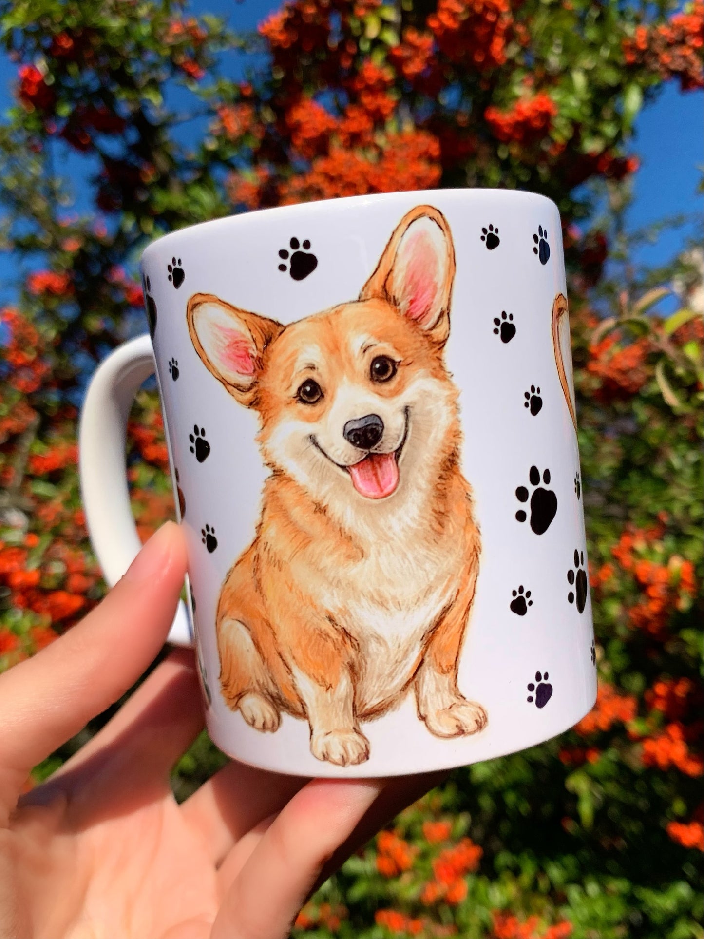 Prémium kerámia Corgi bögre, kétoldalas kézzel festett Corgi illusztrációval: közelről megrajzolt portré és egész alakos kutya, mancsnyomatos háttérrel. Tökéletes corgis ajándék minden gazdinak.