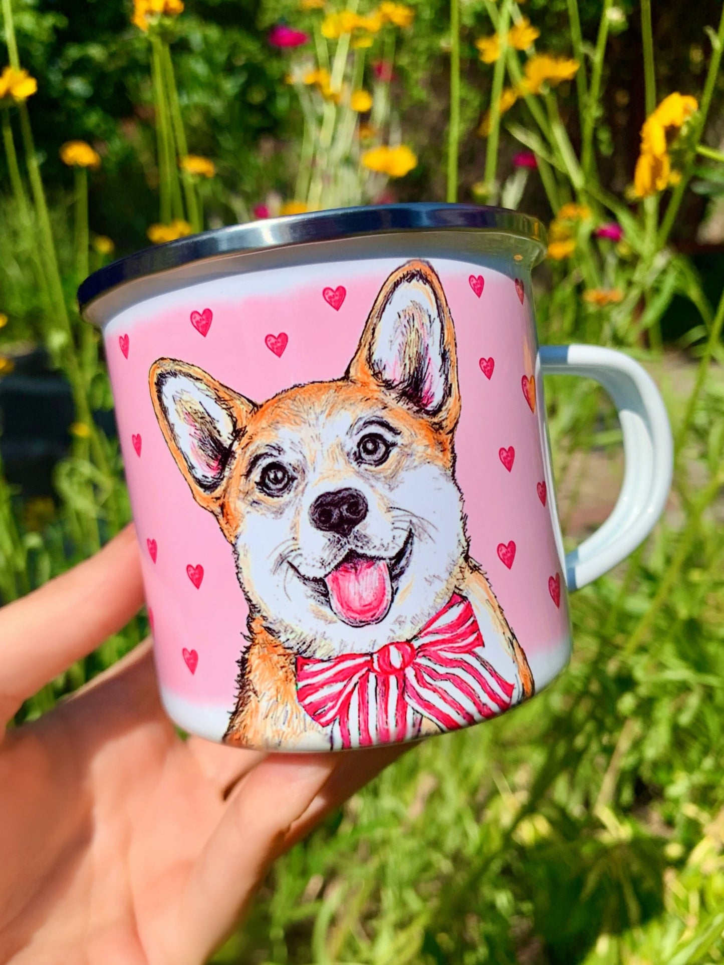 Fém bögre kézzel rajzolt, akvarellfestett világosbarna-fehér Corgi kutyával, nagy mosollyal és rózsaszín szív mintákkal, fehér háttérrel, részletgazdag grafikával.